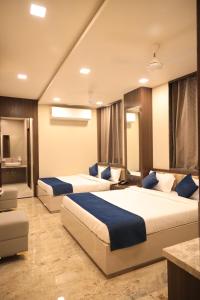 a hotel room with two beds in a room at Hotel Rich Comfort Ajmer in Ajmer