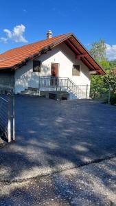 a large white building with a porch and a door at Relax home in Travnik