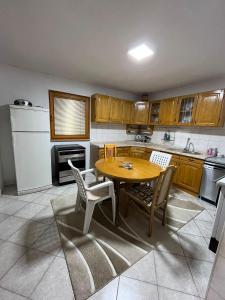 a kitchen with a wooden table and chairs at Relax home in Travnik