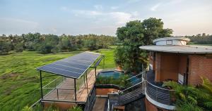 an aerial view of a house with solar panels on the roof at Vayal Heritage Villa in Angamaly +20 photos
