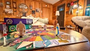 a table in a living room with a board game on it at Re-Up Retreat King Bed, Hot Tub, Zero Pet Fees in Whittier +37 photos