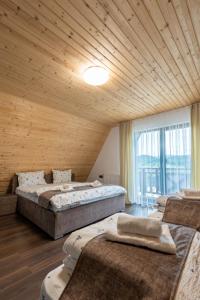 a room with four beds and a large window at Panoramic Hill Jina in Jina