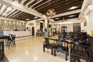 a room with tables and chairs in a store at Swiss Heritage Boutique Hotel Jonker Street Melaka in Malacca