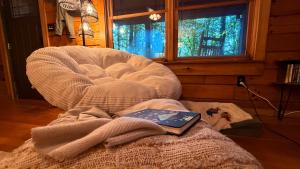 a book sitting on top of a bed in a room at Re-Up Retreat King Bed, Hot Tub, Zero Pet Fees in Whittier