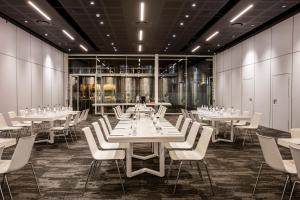 a dining room with white tables and white chairs at The Hazendal Hotel and Spa in Stellenbosch +87 photos