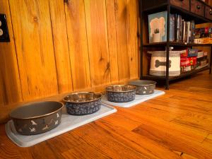 three bowls are sitting on plates on a shelf at Re-Up Retreat King Bed, Hot Tub, Zero Pet Fees in Whittier
