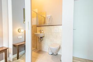 a bathroom with a toilet and a sink at 1 Aprt & 5 Stylish Hotel Rooms, Comfort & Convenience Combined in Vienna +61 photos