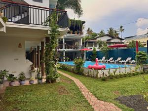 a house with a swimming pool with a red inflatable at Santino Boutique in Mirissa