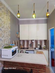 a kitchen with a microwave on top of a counter at Luka in Tbilisi City