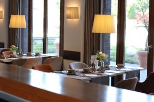 a row of tables in a room with windows at Hotel Begardenhof in Cologne +31 photos