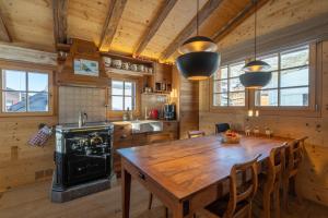 a kitchen with a large wooden table and chairs at Rumpelstilzchen in Bettmeralp
