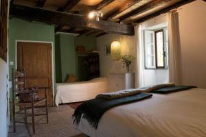 a bedroom with two beds and a window at Les Granges in Bouvières