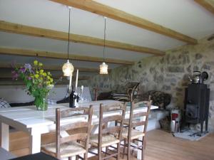 a dining room with a table and chairs at Les Granges in Bouvières