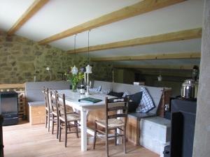 a dining room with a table and chairs at Les Granges in Bouvières +23 photos