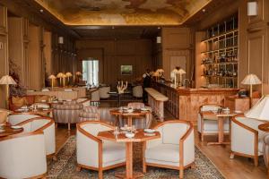 a restaurant with tables and chairs and a bar at The Hazendal Hotel and Spa in Stellenbosch