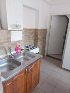 a kitchen with a sink and a stove at Tapolca Centrum-Tapolca Szíve Apartmanok in Tapolca