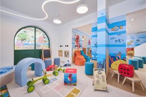 a childs room with a play area with toys at Hotel Garden Istra Plava Laguna in Umag