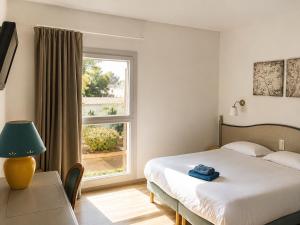 a bedroom with a bed and a window at Chambres de la Bastide des Joncas in Martigues +35 photos