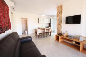 a living room with a couch and a table at Tenuta Zahir in Marina di Mancaversa