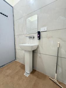a bathroom with a sink and a mirror at Norway Residency in Jagādhri