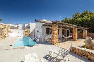 a villa with a swimming pool and a resort at Tenuta Zahir in Marina di Mancaversa
