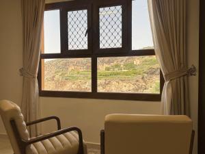 a room with a window with a view of a field at Alsharafh room 3 in Sayq