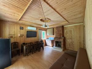 a living room with a couch and a table and a fireplace at Kaghu in Martvili
