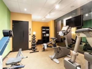 a gym with treadmills and elliptical machines at Le Splendid Hotel Lac D'Annecy - Handwritten Collection in Annecy