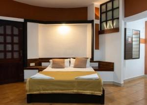 a bedroom with a large bed in a room at Vayal Heritage Villa in Angamaly