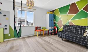 a living room with a couch and a colorful wall at Large apartment in Reykjanes in Ytri-Njarðvík