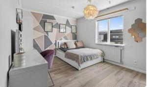 a bedroom with a bed and a window at Large apartment in Reykjanes in Ytri-Njarðvík
