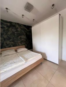 a bedroom with a bed with a painting on the wall at Landidyll am Bauerhof in Sankt Valentin