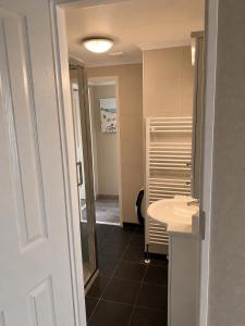 a small bathroom with a sink and a mirror at BLUE BEACH HOUSE in Breskens +35 photos