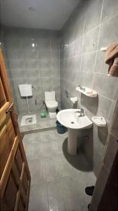 a bathroom with a sink and a toilet at Escape cottage Nathia Gali 