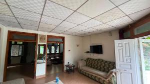 a living room with a couch and a tv at Escape cottage Nathia Gali  +16 photos