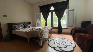 a bedroom with a bed and a large window at Escape cottage Nathia Gali 