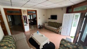 a living room with a couch and a table at Escape cottage Nathia Gali 