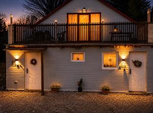 a house with two garage doors and a balcony at U krbu in Jindřichovice +21 photos