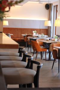 a row of tables and chairs in a restaurant at Hotel Begardenhof in Cologne