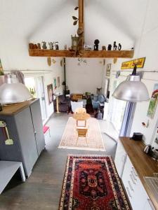 a living room with a table and a rug at Saulgrub Alpen Loft in Saulgrub