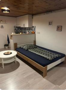 a bed and a table in a room at U krbu in Jindřichovice