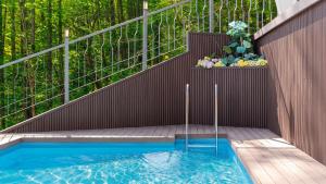 a balcony with a plunge pool and a planter with flowers at Wonju Healing Forest in Wonju