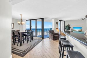 a dining room and living room with a view of the ocean at Aquavista 304W in Panama City Beach