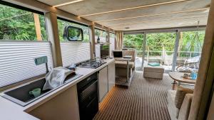 an rv kitchen with a stove and a table at Hafensuite In Templin Uckermark in Templin