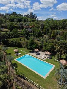 an overhead view of a swimming pool in a yard with grass at Banduja Reserve - Slow by nature in Celorico de Basto