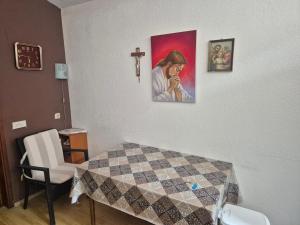 a room with a bed and a cross on the wall at Lila apartments in Bijakovići
