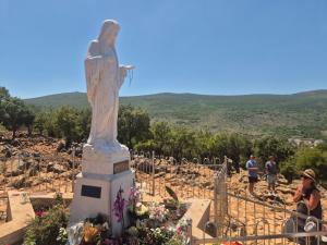 a statue of a woman standing in a cemetery at Lila apartments in Bijakovići