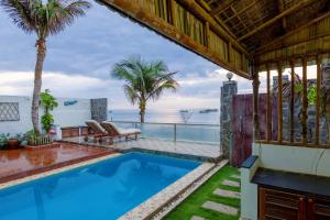 a swimming pool in a house with a view of the ocean at Private Ocean-View Pool Villa, Phan Thiet Beach in Tiến Thành