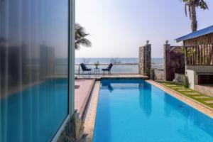 a swimming pool with a view of the ocean at Private Ocean-View Pool Villa, Phan Thiet Beach in Tiến Thành +53 photos