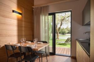 a dining room with a table with wine glasses at The Village Chalet in Castel di Sangro